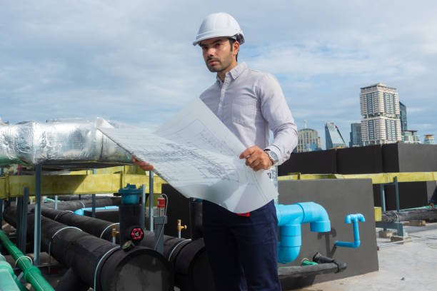 istock Engineer under checking the industry chilled water fan coil unit air conditioner is water cooling tower air chiller HVAC system of large industrial building to control air system 1409282927