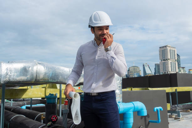 istock Engineer under checking the industry chilled water fan coil unit air conditioner is water cooling tower air chiller HVAC system of large industrial building to control air system 1409282943