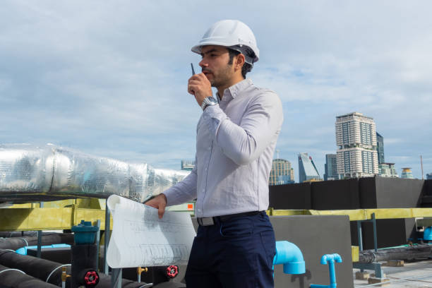 istock Engineer under checking the industry chilled water fan coil unit air conditioner is water cooling tower air chiller HVAC system of large industrial building to control air system 1409283008