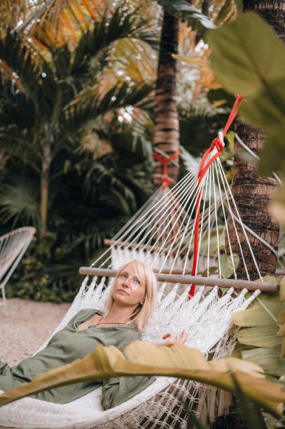 istock Relaxing in Hammocks Surrounded By Tropical Trees 1409283017