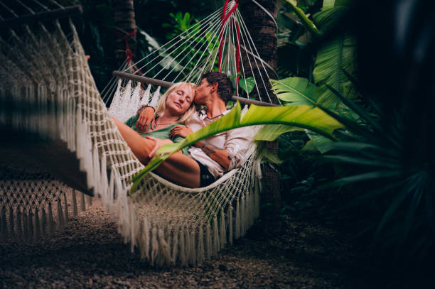 istock Couple enjoy their love while lying down in a hammock 1409283052