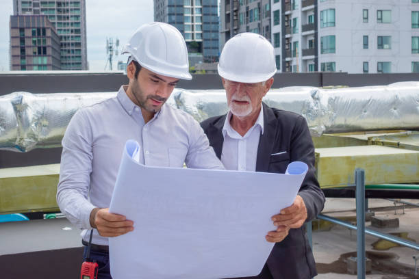 istock Engineer under checking the industry chilled water fan coil unit air conditioner is water cooling tower air chiller HVAC system of large industrial building to control air system 1409283081