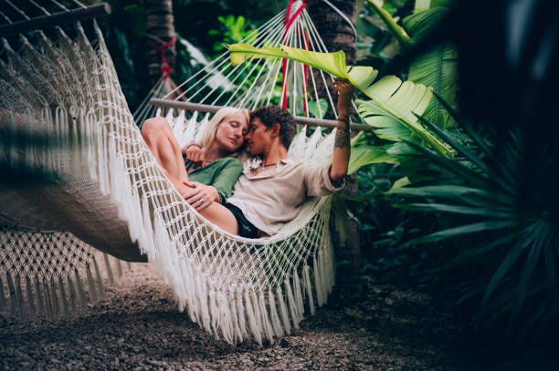 istock Couple enjoy their love while lying down in a hammock 1409283101
