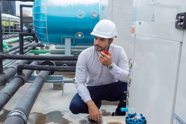 istock Engineer under checking the industry chilled water fan coil unit air conditioner is water cooling tower air chiller HVAC system of large industrial building to control air system 1409283102