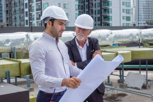 istock Engineer under checking the industry chilled water fan coil unit air conditioner is water cooling tower air chiller HVAC system of large industrial building to control air system 1409283238
