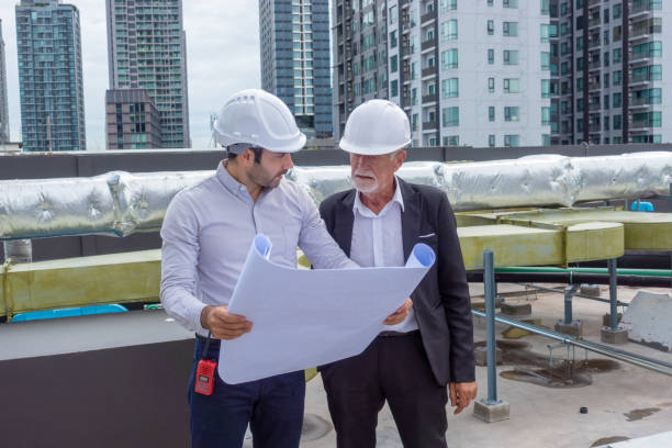 Engineer under checking the industry chilled water fan coil unit air conditioner is water cooling tower air chiller HVAC system of large industrial building to control air system