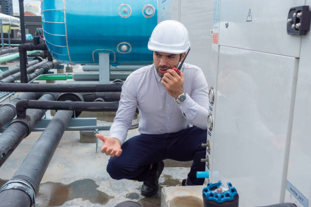 istock Engineer under checking the industry chilled water fan coil unit air conditioner is water cooling tower air chiller HVAC system of large industrial building to control air system 1409283873