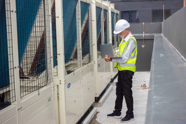 istock Engineer under checking the industry chilled water fan coil unit air conditioner is water cooling tower air chiller HVAC system of large industrial building to control air system 1409284000