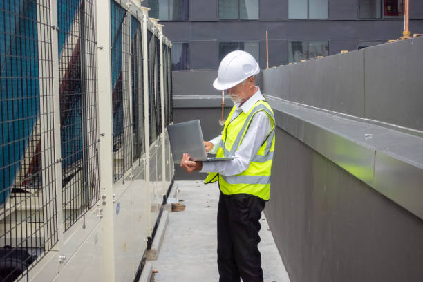 istock Engineer under checking the industry chilled water fan coil unit air conditioner is water cooling tower air chiller HVAC system of large industrial building to control air system 1409284142