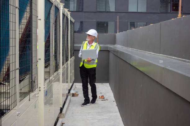 istock Engineer under checking the industry chilled water fan coil unit air conditioner is water cooling tower air chiller HVAC system of large industrial building to control air system 1409284155