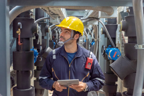 istock Engineer under checking the industry chilled water fan coil unit air conditioner is water cooling tower air chiller HVAC system of large industrial building to control air system 1409284222