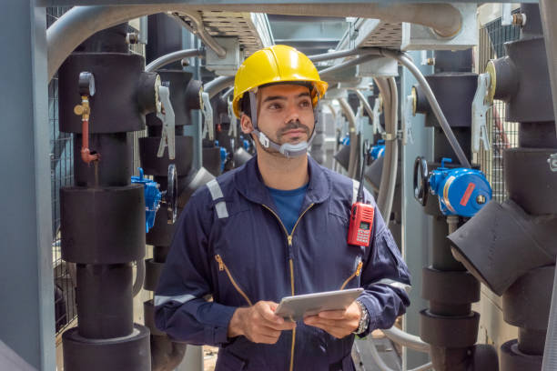 istock Engineer under checking the industry chilled water fan coil unit air conditioner is water cooling tower air chiller HVAC system of large industrial building to control air system 1409284239