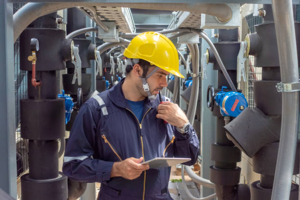 istock Engineer under checking the industry chilled water fan coil unit air conditioner is water cooling tower air chiller HVAC system of large industrial building to control air system 1409284282