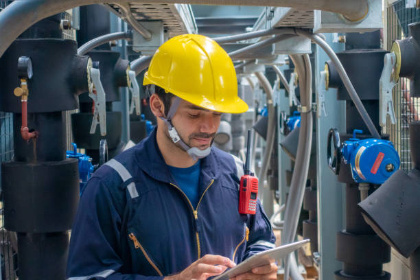 istock Engineer under checking the industry chilled water fan coil unit air conditioner is water cooling tower air chiller HVAC system of large industrial building to control air system 1409284311