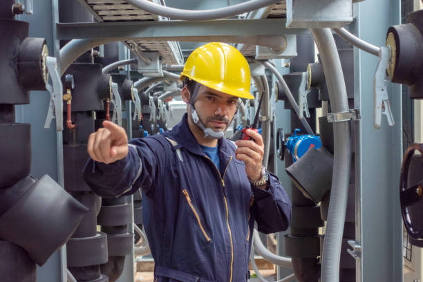 istock Engineer under checking the industry chilled water fan coil unit air conditioner is water cooling tower air chiller HVAC system of large industrial building to control air system 1409284384