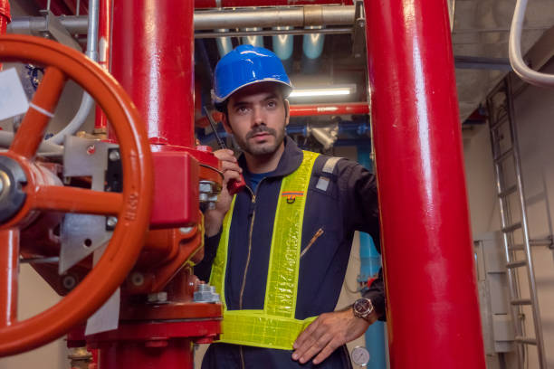 istock Engineer under checking the industry chilled water fan coil unit air conditioner is water cooling tower air chiller HVAC system of large industrial building to control air system 1409284962