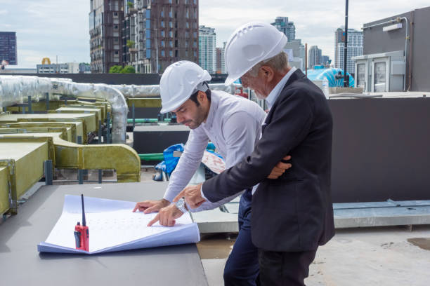 istock Engineer under checking the industry chilled water fan coil unit air conditioner is water cooling tower air chiller HVAC system of large industrial building to control air system 1409284987