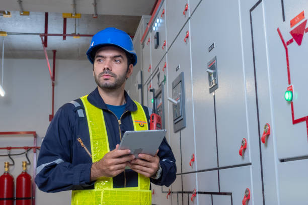 Engineer under checking the industry chilled water fan coil unit air conditioner is water cooling tower air chiller HVAC system of large industrial building to control air system