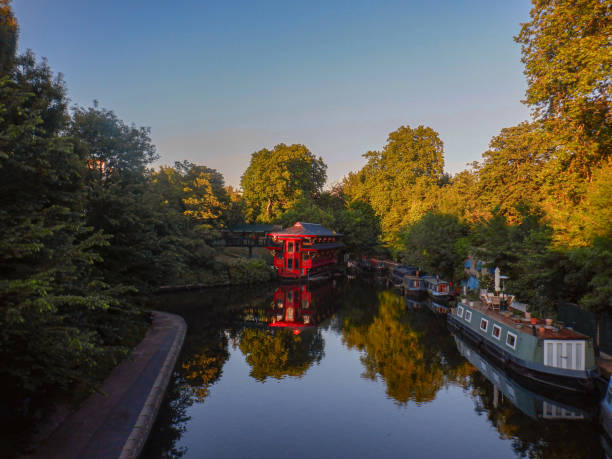 Houseboats at sunset in Camden. Sunset and still canal waters, moored houseboats in Camden, London UK regents canal stock pictures, royalty-free photos & images
