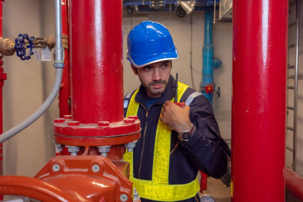 istock Engineer under checking the industry chilled water fan coil unit air conditioner is water cooling tower air chiller HVAC system of large industrial building to control air system 1409285152