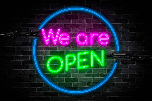istock We are OPEN neon banner on brick wall background, light signboard on the night. 1409285195