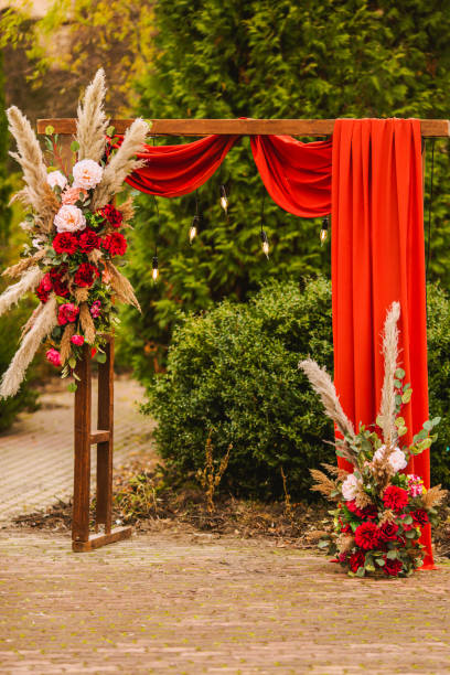 istock Wedding arch in boho style with flowers and light bulbs. Autumn wedding ceremony. Decor. Rustic 1409287720