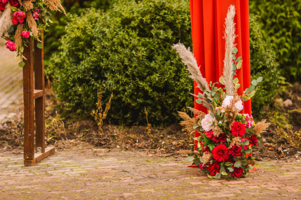 istock Wedding arch in boho style with flowers and light bulbs. Autumn wedding ceremony. Decor. Rustic 1409287844