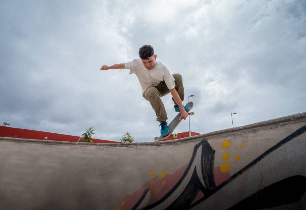 istock young skateboarder jumps over a bowl in a skate park 1409288667