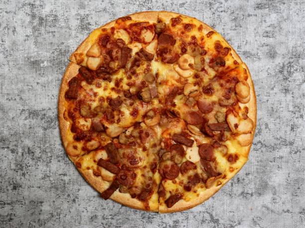istock Pizza with mozzarella, sausage, mushroom, and beef topping on a grey background. 1409289904
