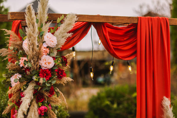 istock Wedding arch in boho style with flowers and light bulbs. Autumn wedding ceremony. Decor. Rustic 1409289913