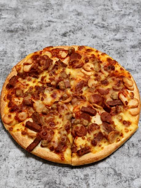 istock Pizza with mozzarella, sausage, mushroom, and beef topping on a grey background. 1409289978