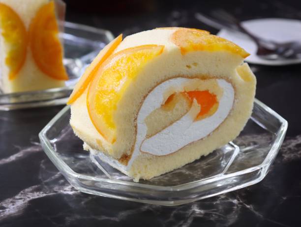 istock Close up of orange chiffon sponge cake roll 1409290175