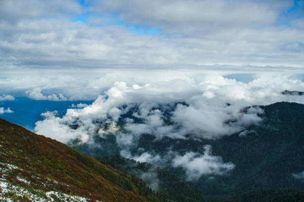 Aerial view above the clouds in mountain valley at morning