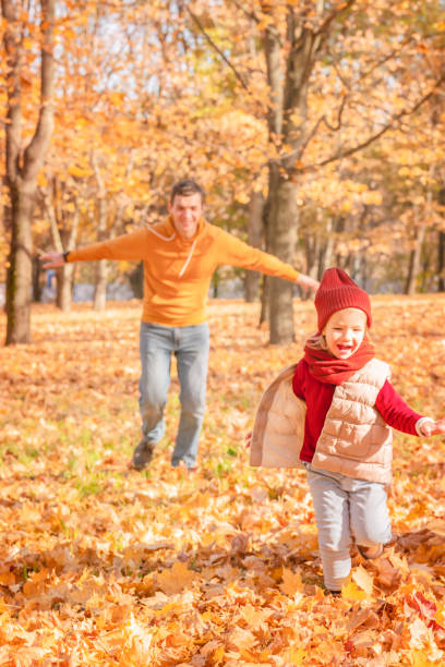 istock Happy father and daughter enjoying autumn 1409293514