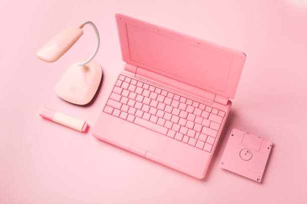 istock Colored pink laptop with bright floppy disk, modernity concept. 1409296070