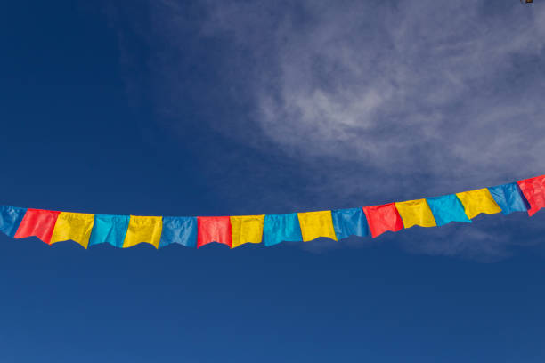 Goiania, Goiás, Brazil – July 17, 2022: A clothesline with fabric pennants against the blue sky for june party - typical brazilian festival. \