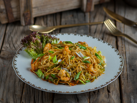 shrimps chinese noodles served in a dish isolated on wooden background side view of noodles
