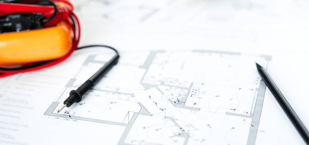 istock Making repairs,planning electricity project in house.Drawings,diagrams,plan for electrification of apartment, building. Devices and accessories, voltmeter, wires, screwdriver, pliers and tape measure 1409296677