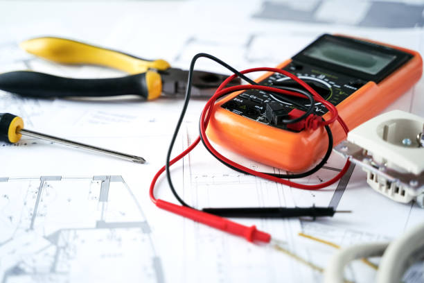 istock Making repairs,planning electricity project in house.Drawings,diagrams,plan for electrification of apartment, building. Devices and accessories, voltmeter, wires, screwdriver, pliers and tape measure 1409296680