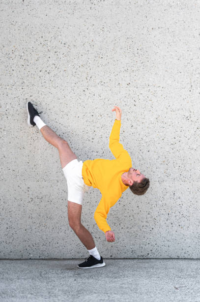 istock Male dancer posing by the concrete wall 1409297687