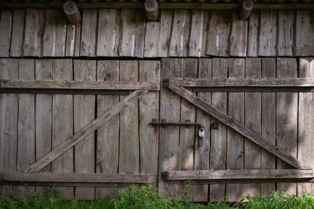 istock Old gate made of weathered boards in a rustic barn. Retro background in eco style. 1409298049