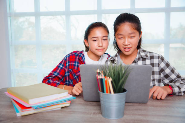 istock Teenager students girls enjoy studying with computer pc 1409303827