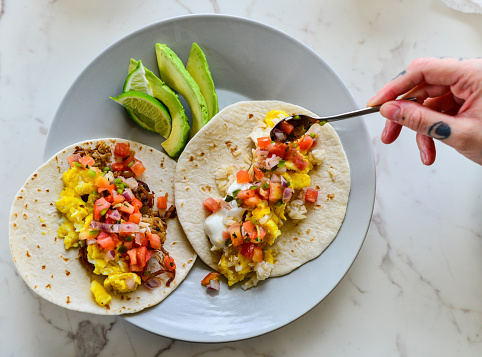 Preparing Breakfast Tacos with Avocado