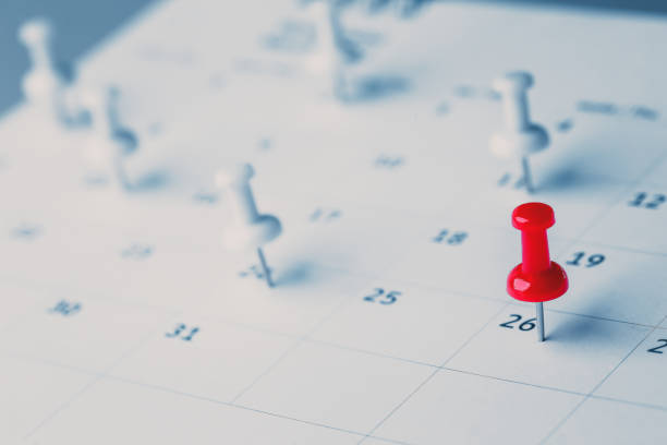 istock Embroidered red pins on a calendar event Planner calendar,clock to set timetable organize schedule,planning for business meeting or travel planning concept. 1409304189