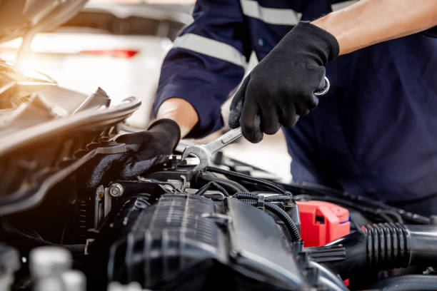 istock Car care maintenance and servicing, Close-up hand technician auto mechanic using the wrench to repairing change spare part car engine problem and insurance service support. 1409304290