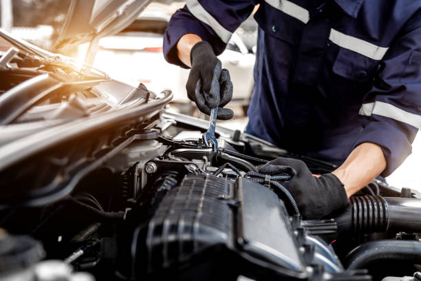 istock Car care maintenance and servicing, Close-up hand technician auto mechanic using the wrench to repairing change spare part car engine problem and insurance service support. 1409304294