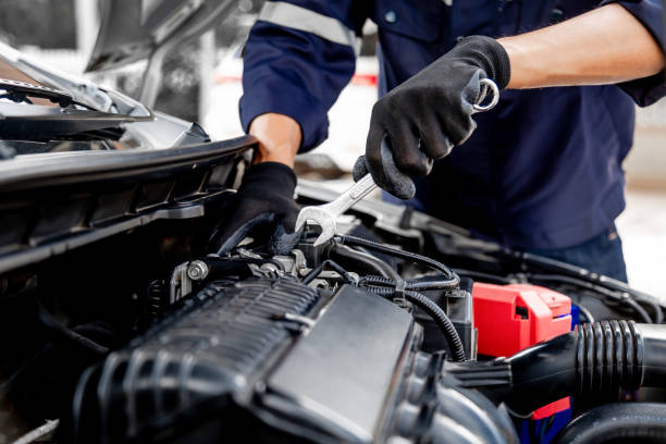 istock Car care maintenance and servicing, Close-up hand technician auto mechanic using the wrench to repairing change spare part car engine problem and insurance service support. 1409304299