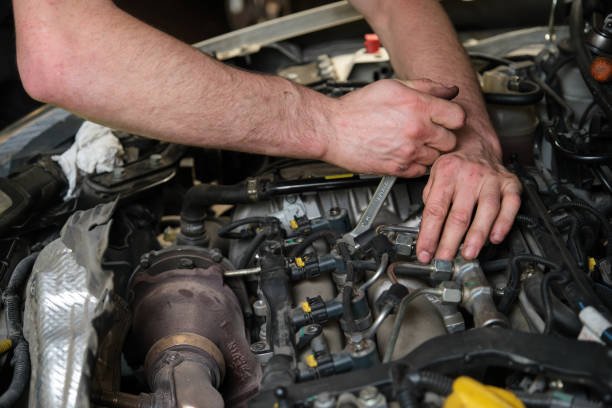 istock Technician removing fuel injectors checking dust and test pressure. 1409306568
