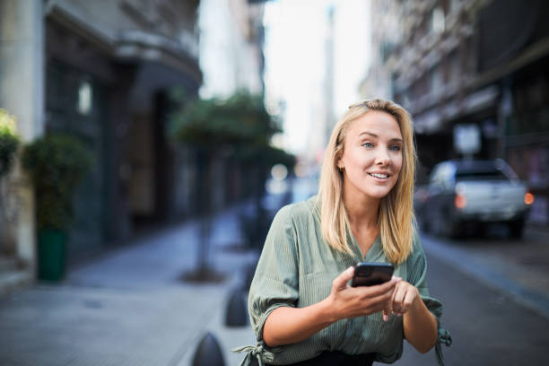 istock A woman in the street is using an app to get a cab. 1409307384