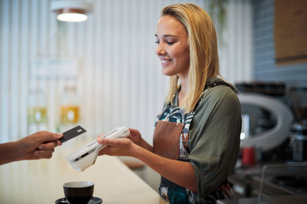 Paying with a contactless card in a coffee shop. stock photo